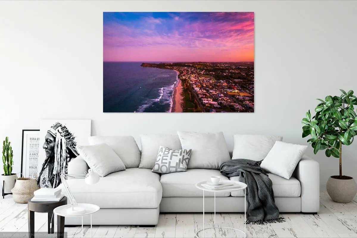 Living room with a large wall art piece of a cityscape at sunset.