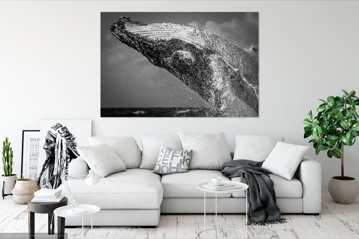 Living room with a white sofa, decorative pillows, and a large black and white whale art print on the wall.